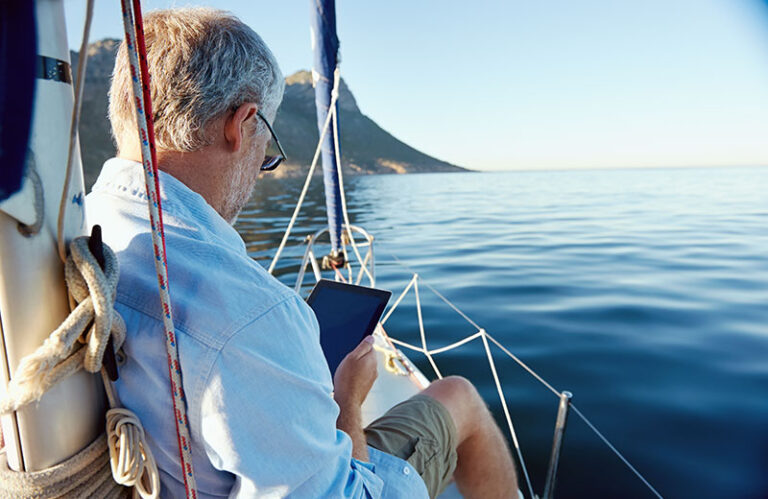 Man on tablet boating